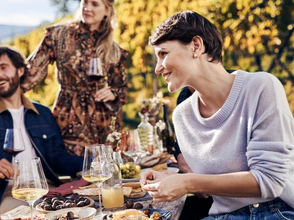 Places of interest in Tramin and the surrounding area Group of friends enjoying wine and snacks at a sunny outdoor picnic.
