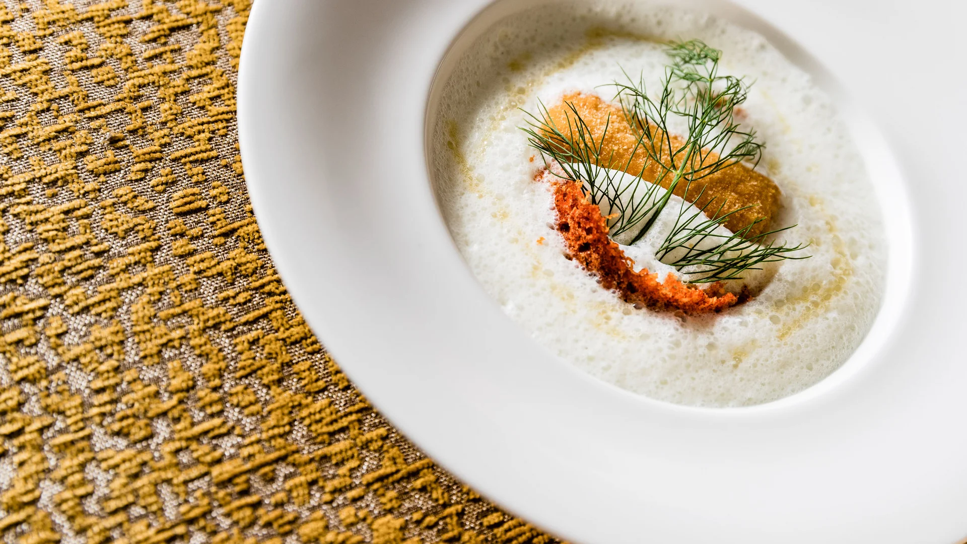 Galleria: impressioni dal Plattenhof a Termeno Delicata zuppa con schiuma, crostini e aneto in piatto bianco